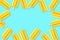 Frame of yellow popsicles against a pastel blue background