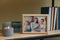 Framed family photo on wooden shelf