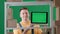 Framed on green background chromakey. Depicted is an adult male wearing a work uniform. Demonstrates a storekeeper in a
