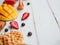 Framed mockup summer breakfast with waffle and fruits. Flat lay with mango, strawberry, and cherry on wooden background