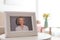 Framed portrait of senior woman on table indoors