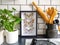 Frames butterflies taxidermy display in a black and white subway tiled kitchen with numerous plants and cooking utensils