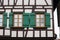 framework historical building facade with green window shutters