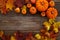 Framework with pumpkins and fall leaves on wooden background. Top view.