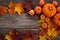 Framework with pumpkins and fall leaves on wooden background. Top view.