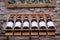 France Burgundy 2019-06-19. Wine bottles in line on wooden rack