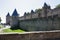 France, Carcassonne- AUGUST 28, 2014. Powerful fortifications and bastions of Carcassonne Castle. Beautiful conical blue roofs of