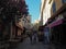 France, Corse, Calvi, June 6, 2017: street in old town with restaurant shops and young family