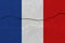France flag on concrete wall with crack