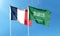 France flag and Saudi Arabia flag on cloudy sky