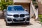 France Lyon 2019-06-20 closeup luxury silver German car jeep premium BMW X4 with EU registration number near vintage stone house