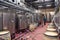 France Lyon 2019-06-20 Modern wine cellar, factory with large metallic clean shine steel fermentation tanks, pouring wine in