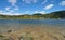 France mountain lake shore with islet Pyrenees