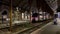 France, Nice, 28 September 2022: A passenger train departs at railway station at night, the janitor cleans up the