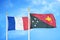 France and Papua New Guinea two flags on flagpoles and blue cloudy sky