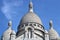 France, Paris - May 2023 - The Basilica de Sacred Heart in Montmartre and blue sky behind