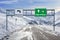 France ski town Mont-de-Lans and Alpe d`Huez road big sign with a lot of snow and mountain sky