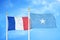 France and Somalia two flags on flagpoles and blue cloudy sky