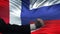 France vs Russia confrontation, countries disagreement, fists on flag background