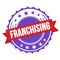 FRANCHISING text on red violet ribbon stamp
