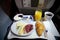 FRANKFURT, GERMANY - JAN 21st, 2017: breakfast on an airplane in Lufthansa Business Class with fresh coffee, orange