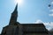 FrauenmÃ¼nster Church, in Zurich, in lateral view, its silhouette against clear blue sky and shining sun in upward perspective