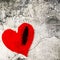 Frayed red heart on cracked wall. Valentine Day graphic.