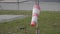 Frayed windsock in moderate wind against blue sky