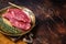 Freah Raw cap rump beef meat steak in a plate with thyme, top sirloin steak. Dark background. Top view. Copy space