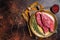 Freah Raw cap rump beef meat steak in a plate with thyme, top sirloin steak. Dark background. Top view. Copy space