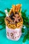 Freakshake from pink smoothie, cream. Monstershake with a chocolate man, cane, pretzels, biscuits, waffles and marshmallow. Extrem