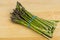 Freash asparagus on wooden cutting board