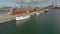 Frederikshavn, Denmark, may 21 2022: Aerial view, three ships moored at the quays, red wooden warehouses on the quays.