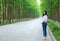 Free carelss woman walk on road in forest outdoor enjoy fresh air