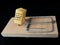 Free cheese in a mousetrap on a black background. Wooden trap with bait and mechanism for rats and mice