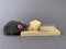 Free cheese in a mousetrap on a gray background. Wooden trap with a bait with a mechanism for rats and mice