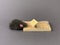 Free cheese in a mousetrap on a gray background. Wooden trap with a bait with a mechanism for rats and mice