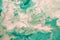 Free flowing beige and green acrylic paint. Abstract marble background or texture. Random Waves and Curls