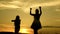 Free girls dancing on the beach. party by the lake. beautiful girls having fun listening to music. sisters are dancing