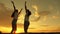 Free girls are dancing cheerfully on a summer evening at sunset. outdoor celebration. Celebrate a summer day with a