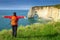 Free happy woman enjoying nature, Etretat, Normandy, France