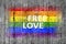 Free Love and LGBT flag painted on background texture gray concrete