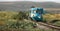 Free Privat train going through green meadows in Romania