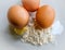 Free range eggs seen with flour and butter for making a cake.