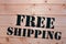 Free Shipping. Free Shipping word on wooden transport box. Free Shipping Package.