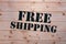 Free Shipping. Free Shipping word on wooden transport box. Free Shipping Package.