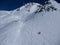 Free ski slope on a clear winter day, few people ride, behind visible peaks of Elbrus. Russia, Elbrus region - february,2010