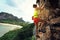 Free solo woman rock climber climbing