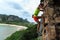 Free solo woman rock climber climbing