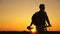 A free traveler travels with a bicycle at sunset. Hiker healthy guy goes with a bicycle around field, enjoying nature